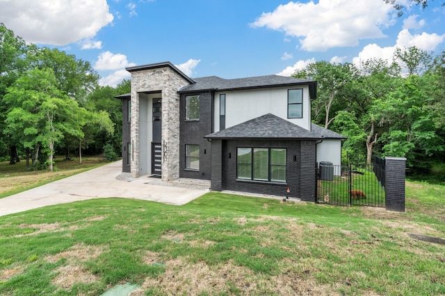 2303 Timber Creek Ct, Cedar Hill, TX 75104 - view of front facade with a shingled roof, stone siding, and central AC