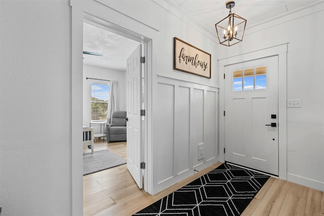 207 W River, Meridian, TX 76665 - entrance foyer with wood finished floors and a chandelier