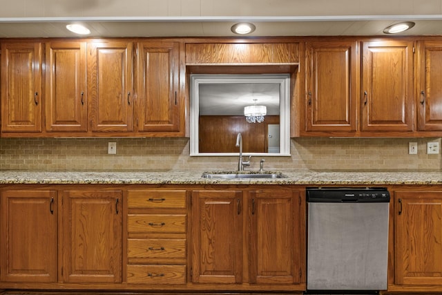 1108 Quitman St, Pittsburg, TX 75686 - kitchen with stainless steel dishwasher, a sink, and brown cabinets