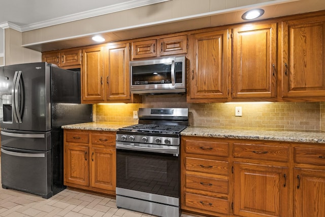 1108 Quitman St, Pittsburg, TX 75686 - kitchen featuring appliances with stainless steel finishes, crown molding, and brown cabinetry