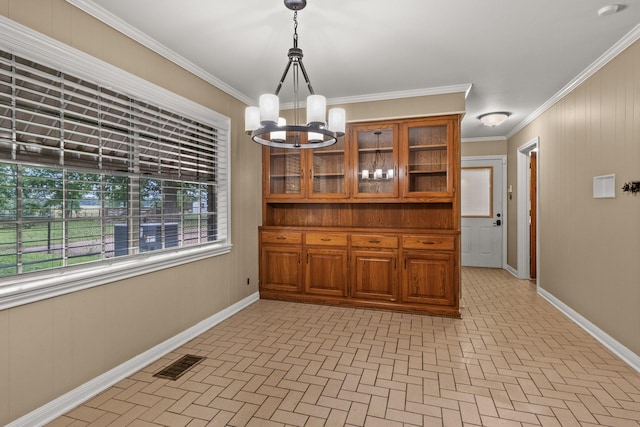 1108 Quitman St, Pittsburg, TX 75686 - dining space featuring brick patterned flooring, a chandelier, baseboards, and crown molding