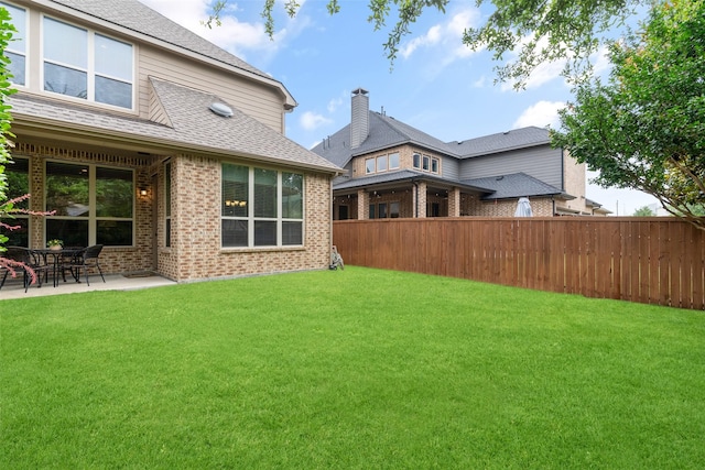 843 Bear Crossing Dr, Allen, TX 75013 - back of property with brick siding, a patio area, and roof with shingles