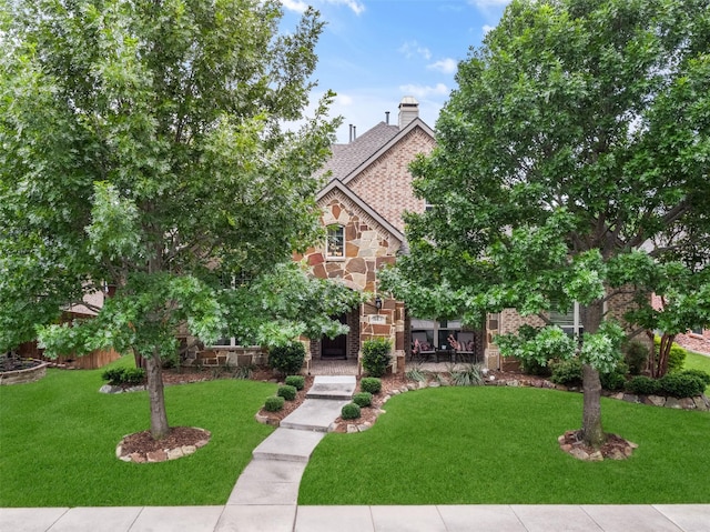 843 Bear Crossing Dr, Allen, TX 75013 - view of property hidden behind natural elements with a front yard, stone siding, brick siding, and a chimney