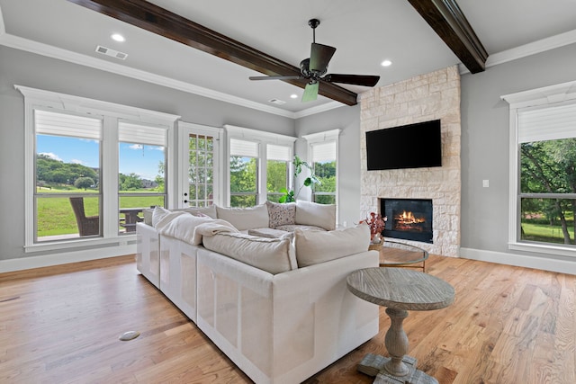 1803 Sunset Xing, Cedar Hill, TX 75104 - living area featuring beamed ceiling, a fireplace, a ceiling fan, baseboards, and light wood-type flooring