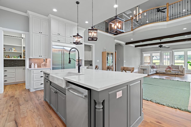 1803 Sunset Xing, Cedar Hill, TX 75104 - kitchen with stainless steel appliances, gray cabinets, a sink, a chandelier, and arched walkways