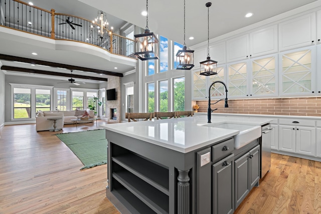 1803 Sunset Xing, Cedar Hill, TX 75104 - kitchen with gray cabinetry, a sink, a towering ceiling, white cabinetry, and light countertops