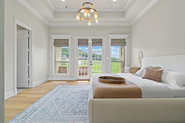 1803 Sunset Xing, Cedar Hill, TX 75104 - bedroom featuring a tray ceiling, wood finished floors, a chandelier, access to exterior, and french doors