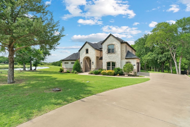 1803 Sunset Xing, Cedar Hill, TX 75104 - french country home featuring brick siding, a water view, driveway, a front lawn, and stone siding