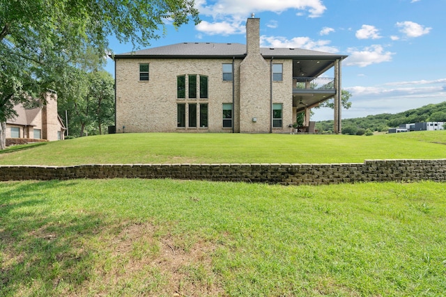 1803 Sunset Xing, Cedar Hill, TX 75104 - rear view of house with a lawn, a balcony, a ceiling fan, and a chimney
