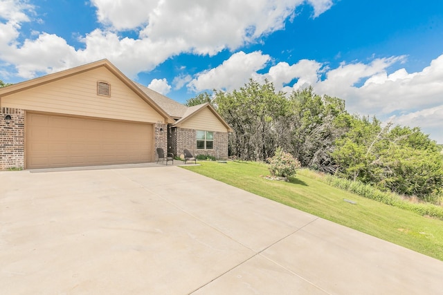 2614 Creek Dr, Granbury, TX 76048 - single story home featuring brick siding, concrete driveway, a front yard, and an attached garage