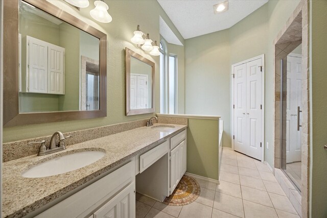 6404 Westgate Dr, North Richland Hills, TX 76182 - full bathroom with double vanity, tile patterned flooring, and a stall shower