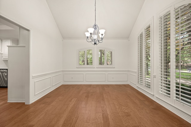 1535 Windsor Forest Trl, Keller, TX 76262 - unfurnished dining area with lofted ceiling, a chandelier, wood finished floors, wainscoting, and a decorative wall