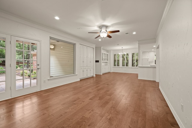 1535 Windsor Forest Trl, Keller, TX 76262 - unfurnished living room featuring a ceiling fan, ornamental molding, wood finished floors, recessed lighting, and a chandelier