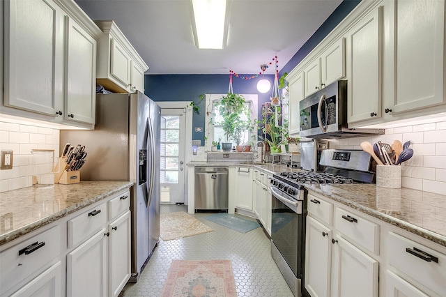 2108 Fairmount Ave, Fort Worth, TX 76110 - kitchen featuring stainless steel appliances, decorative backsplash, a sink, light stone countertops, and light tile patterned floors