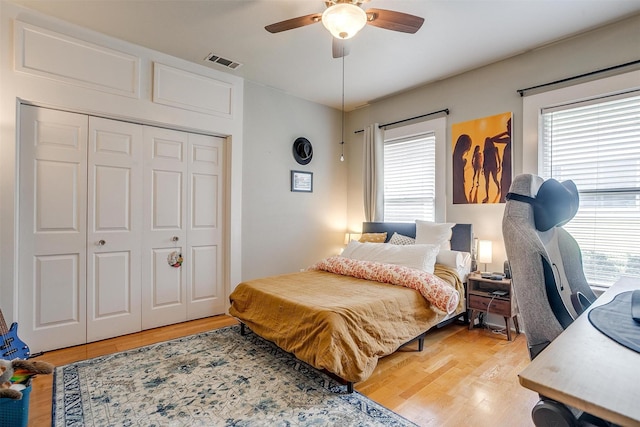 2108 Fairmount Ave, Fort Worth, TX 76110 - bedroom featuring multiple windows, wood finished floors, and a closet