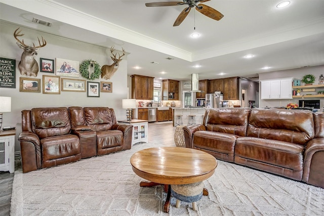 1107 Perkins Rd, Poolville, TX 76487 - living room featuring ornamental molding, recessed lighting, a ceiling fan, and a raised ceiling
