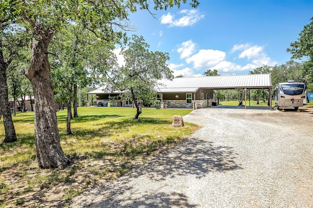 1107 Perkins Rd, Poolville, TX 76487 - view of front facade with driveway, a front lawn, and metal roof