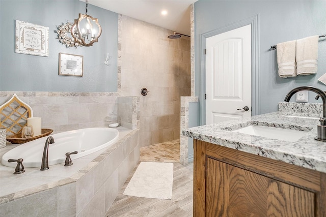 1107 Perkins Rd, Poolville, TX 76487 - bathroom with a bath, vanity, a walk in shower, and a chandelier