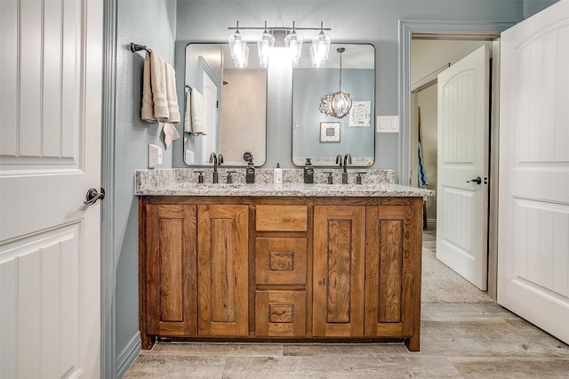 1107 Perkins Rd, Poolville, TX 76487 - bathroom featuring double vanity and wood finished floors