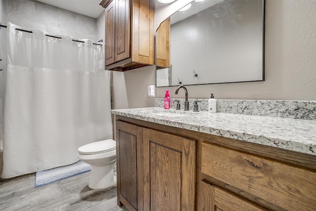 1107 Perkins Rd, Poolville, TX 76487 - full bath featuring wood finished floors, toilet, and vanity
