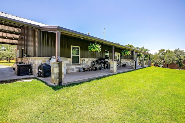 1107 Perkins Rd, Poolville, TX 76487 - back of house featuring board and batten siding, a patio, and stone siding