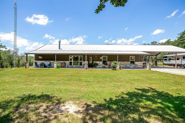 1107 Perkins Rd, Poolville, TX 76487 - back of property featuring a carport, board and batten siding, a lawn, metal roof, and stone siding
