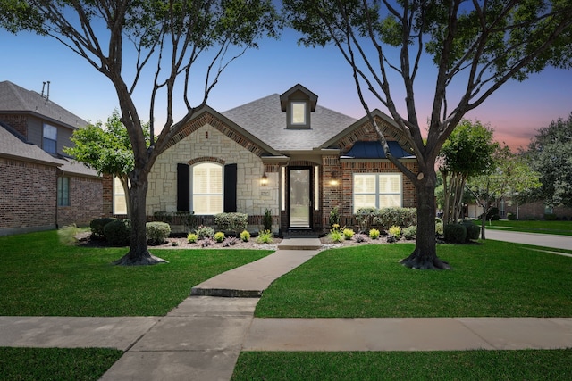 2707 Barnhill Ln, Frisco, TX 75034 - french provincial home featuring a lawn, stone siding, and brick siding