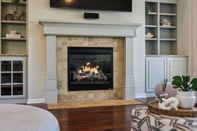 2707 Barnhill Ln, Frisco, TX 75034 - detailed view of wood finished floors, a fireplace, built in shelves, and baseboards