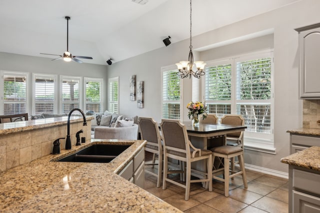 2707 Barnhill Ln, Frisco, TX 75034 - kitchen with a sink, vaulted ceiling, ceiling fan, light tile patterned floors, and decorative light fixtures