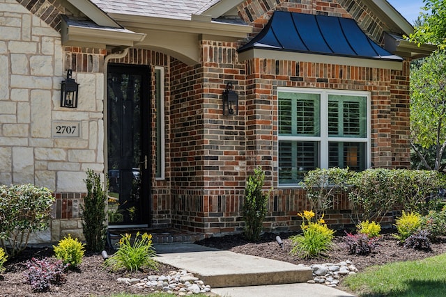 2707 Barnhill Ln, Frisco, TX 75034 - entrance to property featuring a standing seam roof, brick siding, metal roof, and stone siding