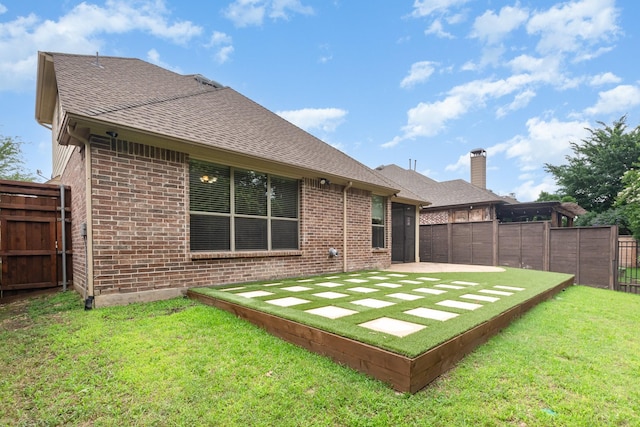 1416 Tangle Ridge Dr, Mckinney, TX 75071 - rear view of property featuring brick siding, roof with shingles, a patio, and a chimney