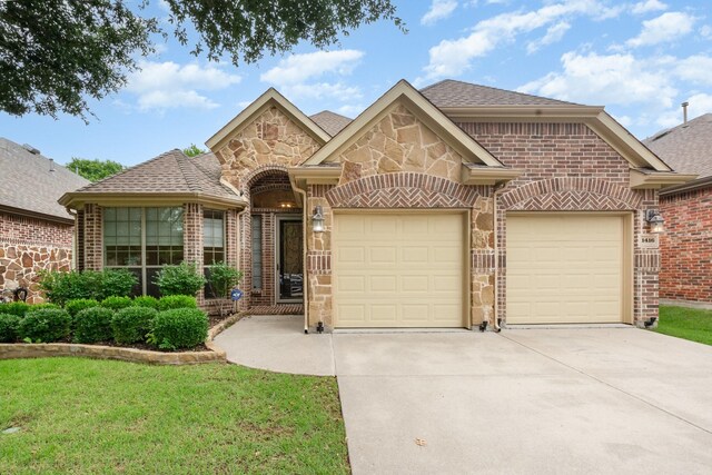 1416 Tangle Ridge Dr, Mckinney, TX 75071 - french country inspired facade featuring driveway, a garage, stone siding, and brick siding