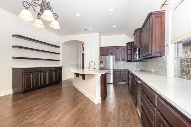 1416 Tangle Ridge Dr, Mckinney, TX 75071 - kitchen with arched walkways, stainless steel appliances, tasteful backsplash, light countertops, and a chandelier