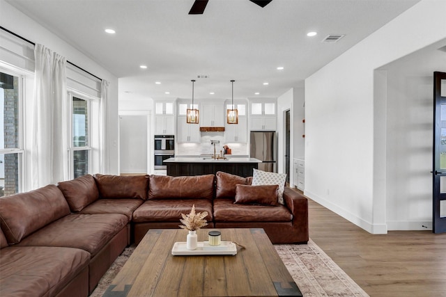 2418 Spirit Ct, Tolar, TX 76476 - living area featuring light wood-style flooring, recessed lighting, healthy amount of natural light, ceiling fan, and baseboards