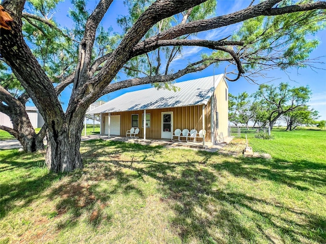 5260 County Road 268, Anson, TX 79501 - view of front facade featuring a front lawn, a garage, and metal roof