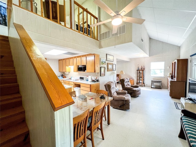 5260 County Road 268, Anson, TX 79501 - dining room featuring light floors, stairs, a ceiling fan, and lofted ceiling
