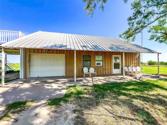 5260 County Road 268, Anson, TX 79501 - view of front of home featuring a garage, board and batten siding, and covered porch