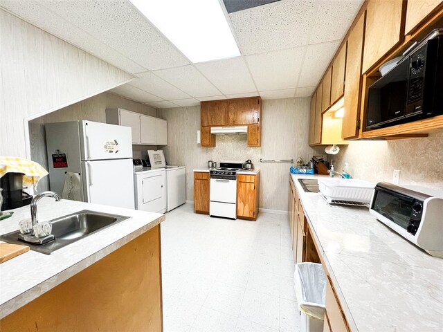 5260 County Road 268, Anson, TX 79501 - kitchen with white appliances, independent washer and dryer, a sink, a drop ceiling, and light countertops