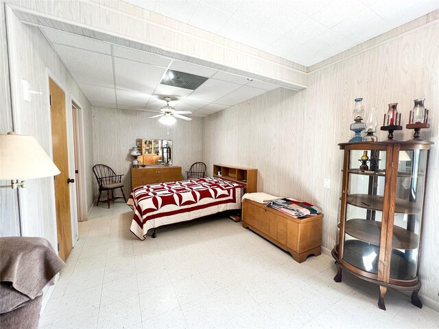 5260 County Road 268, Anson, TX 79501 - bedroom featuring tile patterned floors, ceiling fan, and a drop ceiling