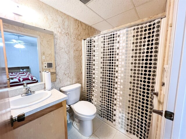 5260 County Road 268, Anson, TX 79501 - bathroom featuring a paneled ceiling, vanity, toilet, ceiling fan, and connected bathroom