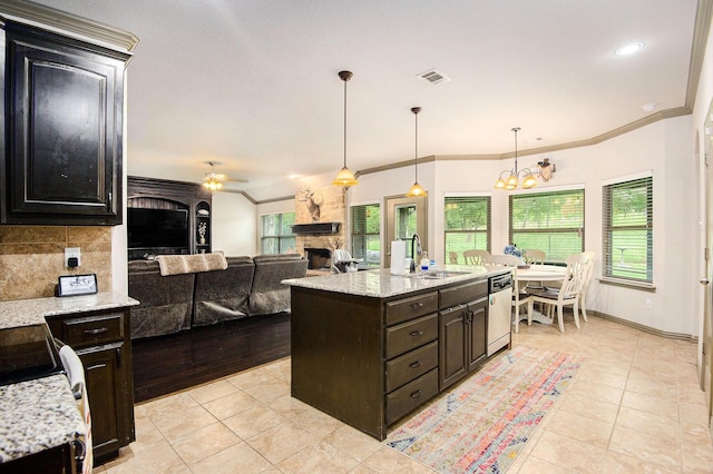 407 Dill Rd, Weatherford, TX 76085 - kitchen featuring stainless steel appliances, a stone fireplace, light tile patterned floors, ornamental molding, and backsplash