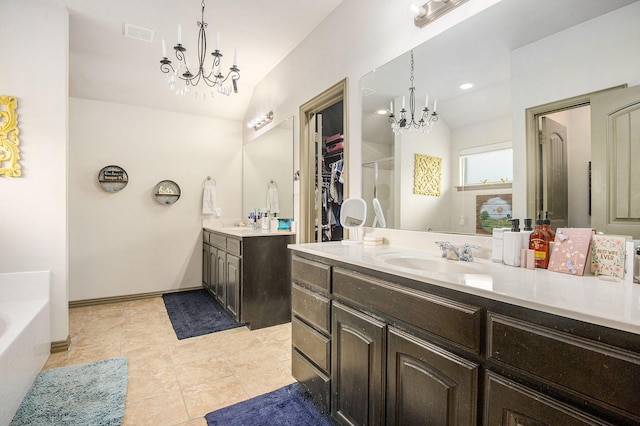 407 Dill Rd, Weatherford, TX 76085 - full bath with a chandelier, two vanities, a garden tub, and tile patterned floors