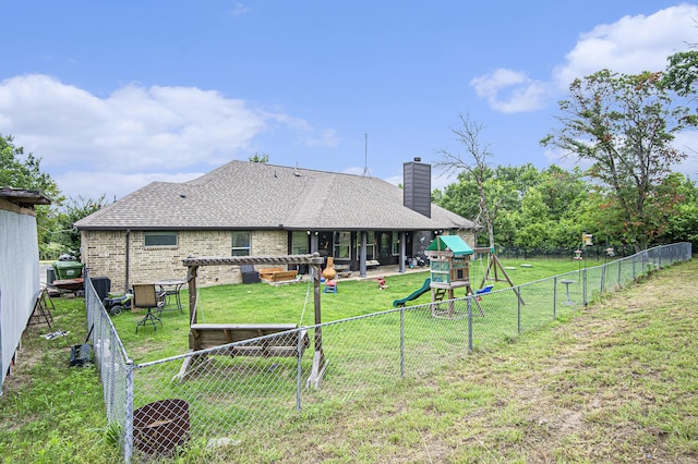 407 Dill Rd, Weatherford, TX 76085 - rear view of property with a playground, a fenced backyard, a chimney, brick siding, and a shingled roof