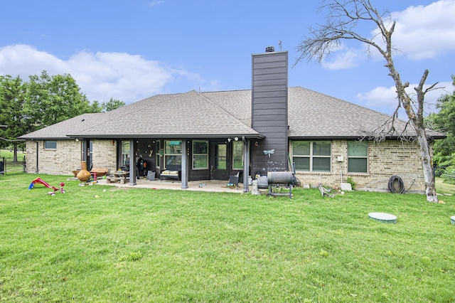 407 Dill Rd, Weatherford, TX 76085 - rear view of house with a chimney, a patio area, brick siding, and a lawn