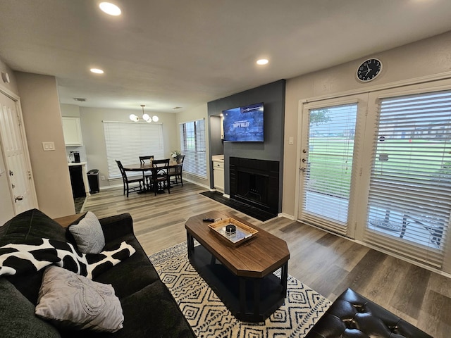 5913 Lake Hubbard Pkwy Unit 124, Garland, TX 75043 - living area with plenty of natural light, a chandelier, recessed lighting, light wood-type flooring, and a fireplace with flush hearth
