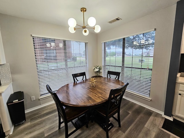 5913 Lake Hubbard Pkwy Unit 124, Garland, TX 75043 - dining room with a chandelier, dark wood-style flooring, and baseboards