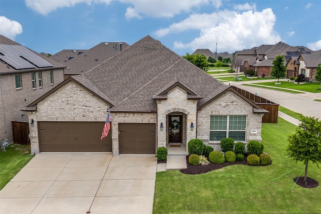 2921 Crossbow Ln, Celina, TX 75009 - french provincial home with brick siding, an attached garage, driveway, and roof with shingles