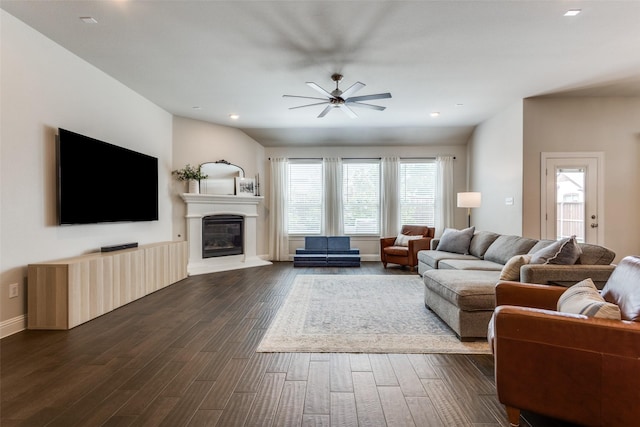 2921 Crossbow Ln, Celina, TX 75009 - living area with ceiling fan, dark wood-type flooring, recessed lighting, a glass covered fireplace, and baseboards