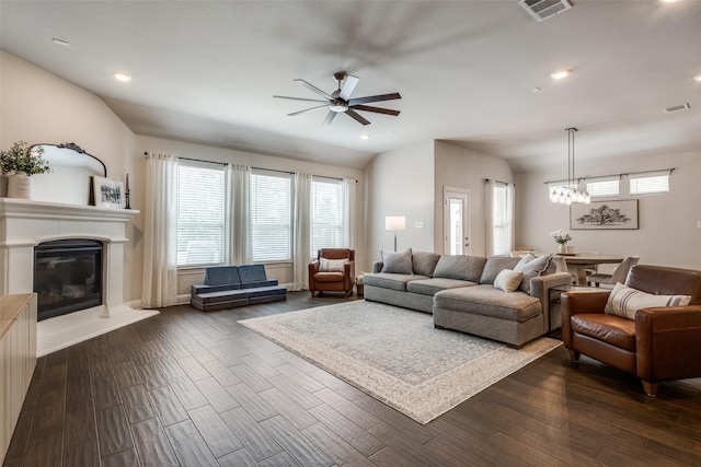 2921 Crossbow Ln, Celina, TX 75009 - living room with a ceiling fan, a chandelier, a glass covered fireplace, dark wood-style flooring, and plenty of natural light