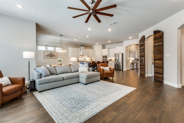 2921 Crossbow Ln, Celina, TX 75009 - living room featuring arched walkways, a ceiling fan, dark wood-style flooring, recessed lighting, and baseboards